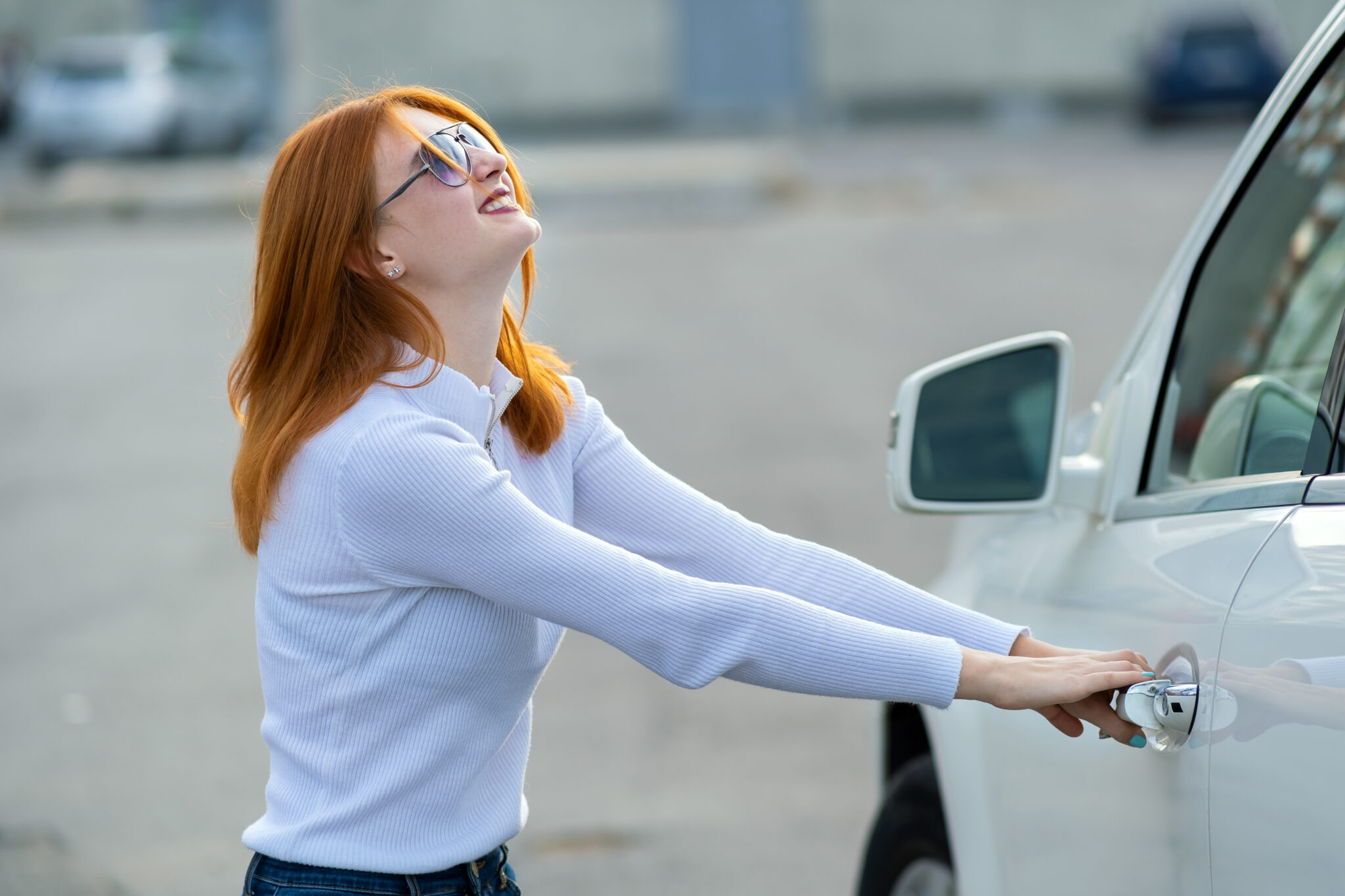 A woman trying to open closed car doors